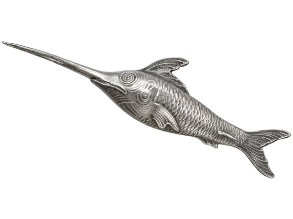 Antique silver sewing stiletto in the form of a swordfish, shown on white background.