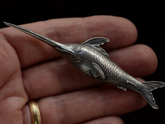 thumbnail of Antique silver sewing stiletto in the form of a swordfish, shown held in hand
