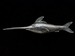 thumbnail of Antique silver sewing stiletto in the form of a swordfish, shown on black background.