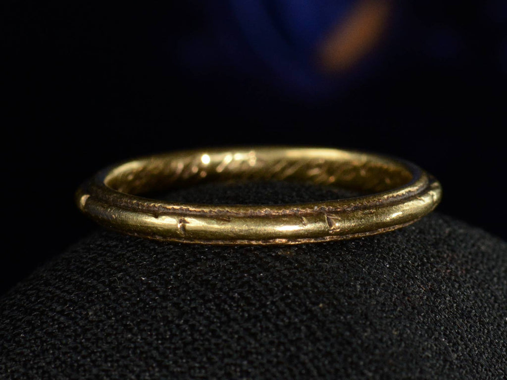 Front view of 1921 Decorated 18K Yellow Gold Band (on dark background)