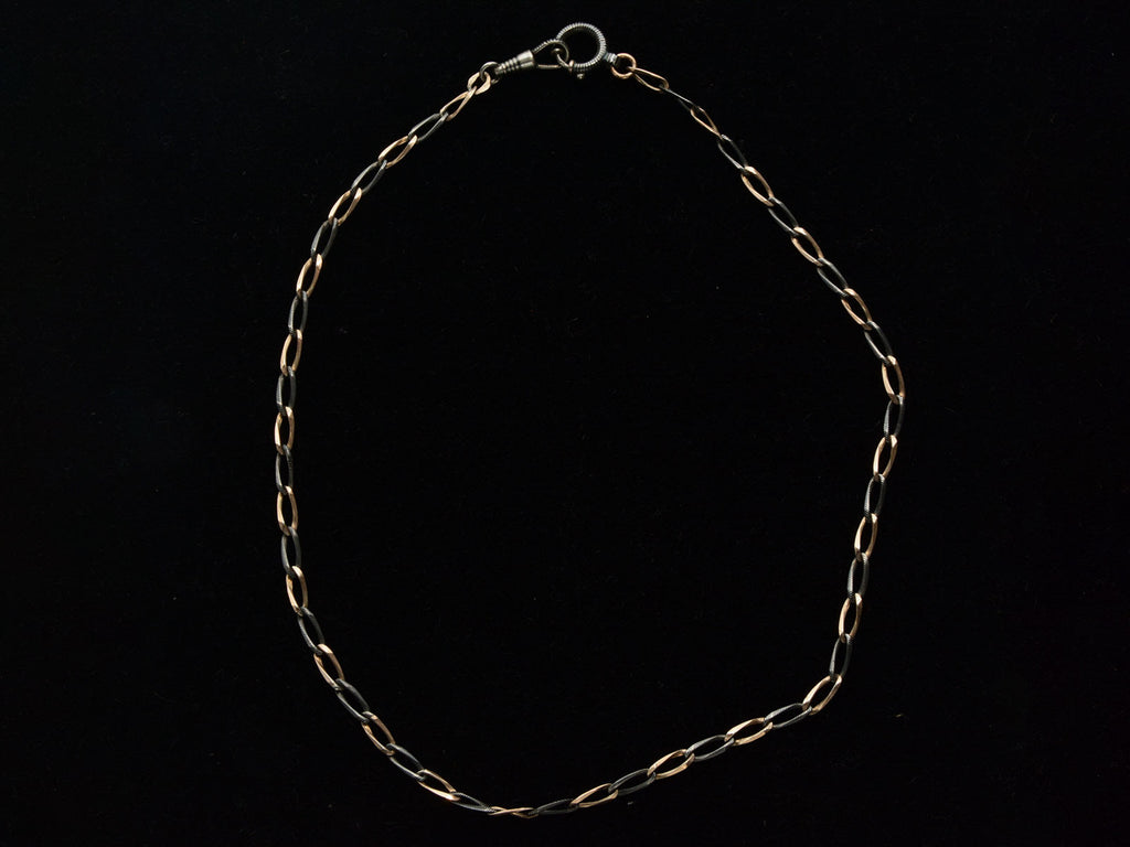 c1900 Thin Antique Chain of Alternating Links of Gilt Silver and Striped Niello (shown on black background)