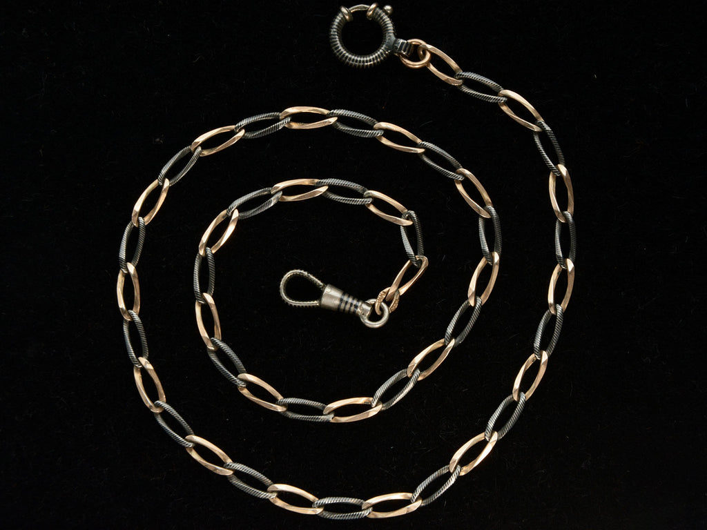 c1900 Thin Antique Chain of Alternating Links of Gilt Silver and Striped Niello (shown spiraled on black background)