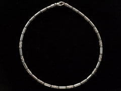 thumbnail of A vintage Tiffany "Aztec" necklace with barrel-shaped sterling silver beads interspersed with narrow bands of hematite and alternating with zig-zag embellished beads, shown on black background.