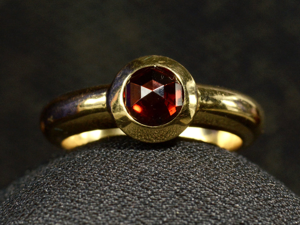 Front of Vintage Tiffany Ring with Rose Cut Red Garnet set in heavy 18K Yellow Gold Mounting (on dark background)