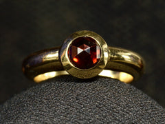 thumbnail of Front of Vintage Tiffany Ring with Rose Cut Red Garnet set in heavy 18K Yellow Gold Mounting (on dark background)