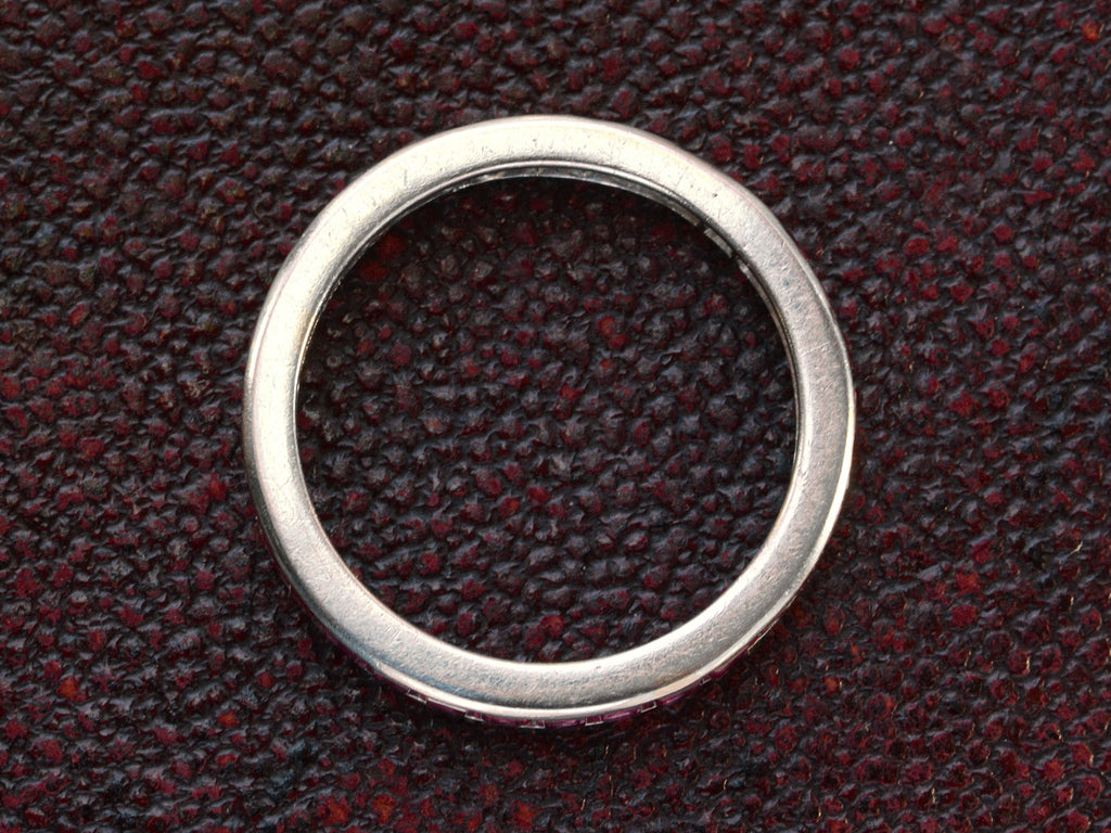 Side profile of c1950 Tiffany & Co platinum eternity band  on dark textured background.