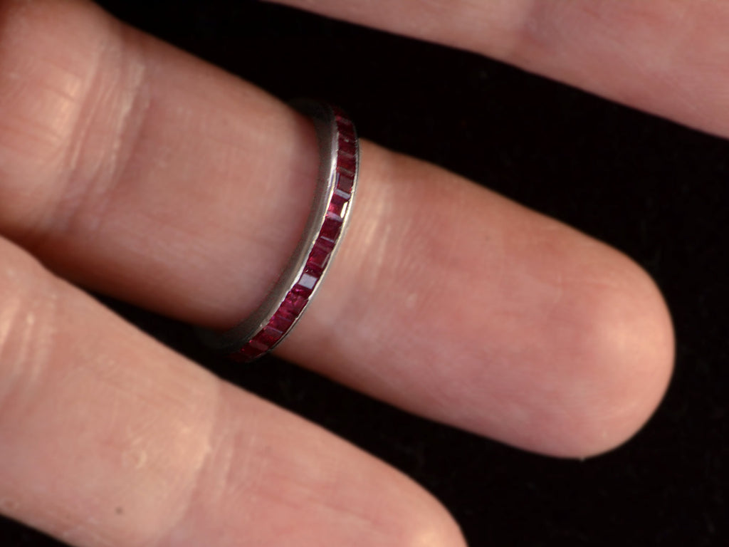 c1950 Tiffany & Co platinum eternity band  with square red rubies, shown on finger.