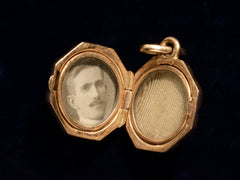 thumbnail of c1890 Tiny Gold Locket (shown open with a photograph of a man, on black background)