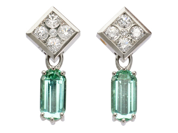 A pair of c1990 white gold earrings with diamond-shaped diamond studded tops and teal tourmaline pendants (on white background)