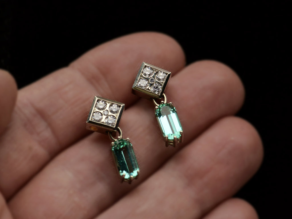 A pair of c1990 white gold earrings with diamond-shaped diamond studded tops and teal tourmaline pendants (on hand)