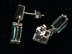 thumbnail of Alternate side profile and back view of c1990 white gold earrings with diamond-shaped diamond studded tops and teal tourmaline pendants (on black background).