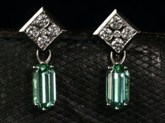 thumbnail of Front view of c1990 white gold earrings with diamond-shaped diamond studded tops and teal tourmaline pendants (on dark background). 