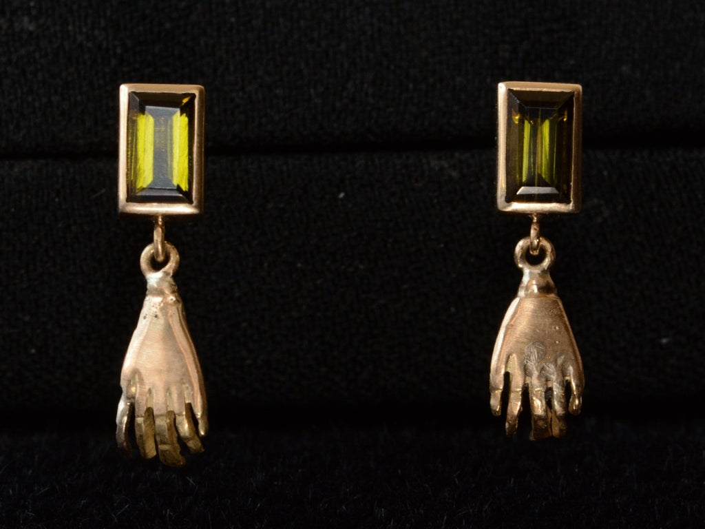 EB Modern Earrings with Rectangular Olive Colored Tourmaline Tops and Hand Pendants in Yellow Gold (shown on black background)