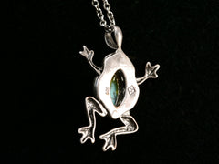 thumbnail of Reverse side of silver frog pendant with turquoise stone on a black background. Stamps visible "925" and "JS"
