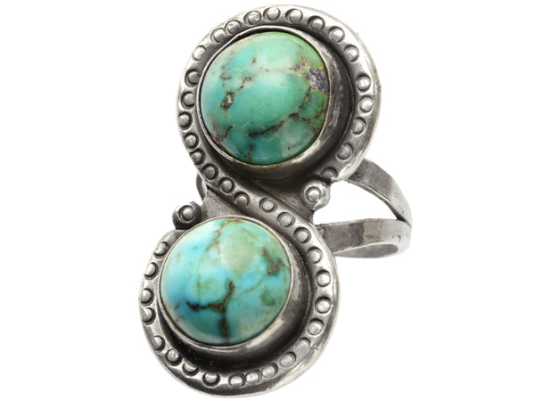 Right angled front view of Silver ring with two turquoise stones on a white background