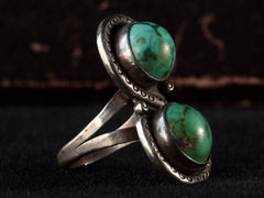 thumbnail of Left angled side view of Silver ring with two turquoise stones on a black background

