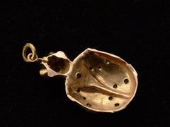 thumbnail of Reverse side of vintage turtle shaped pendant in white and yellow gold with diamond and ruby details. shown on black background.