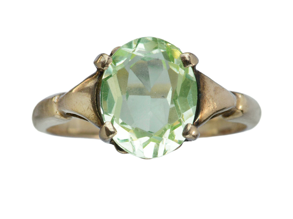 Art Deco ring with oval pale green stone set in rosy-yellow gold, shown on white background.