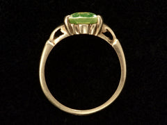 thumbnail of Side profile of Art Deco ring with oval pale green stone set in rosy-yellow gold, shown on black background.