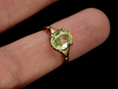 thumbnail of Art Deco ring with oval pale green stone set in rosy-yellow gold, shown on finger.