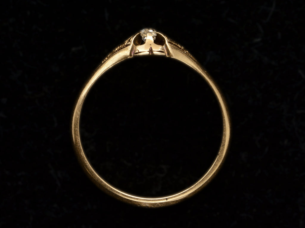 Side profile of c1880 Victorian belcher setting engagement ring with a small old mine cut diamond set in yellow gold, shown on black background.