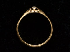 thumbnail of Side profile of c1880 Victorian belcher setting engagement ring with a small old mine cut diamond set in yellow gold, shown on black background.
