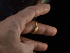 thumbnail of c1920 Wide 18K yellow gold wedding band with edge detailing. On finger.