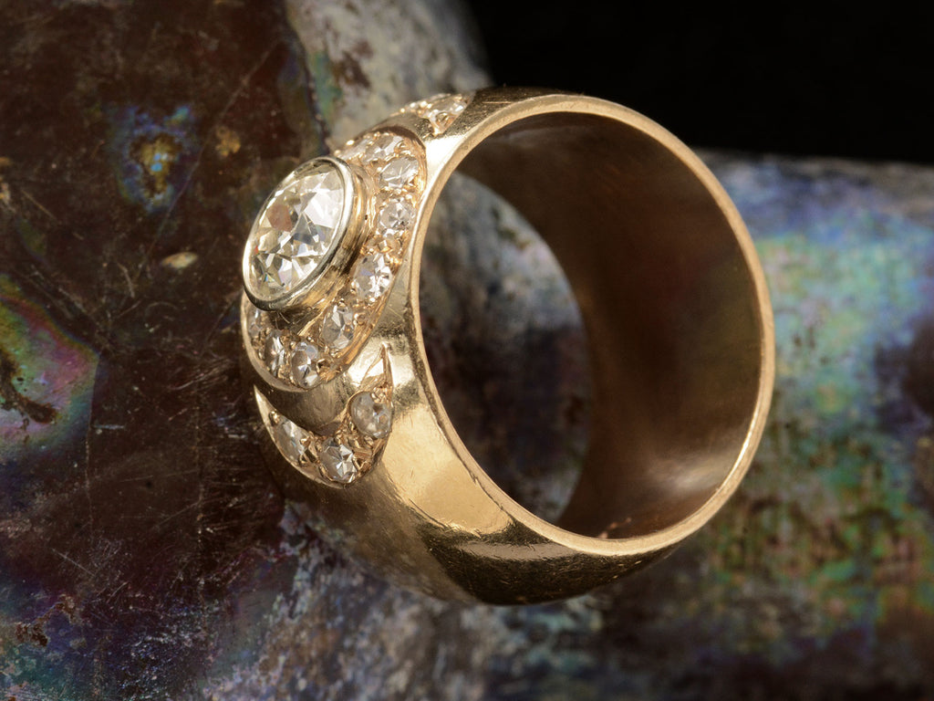 Side view of a c1980 Wide Yellow Gold Band set with Clusters of Old Cut Diamonds (on dark textured background)