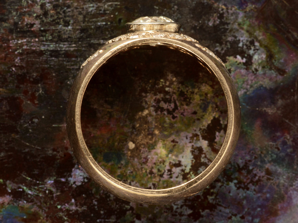 Side profile of a c1980 Wide Yellow Gold Band set with Clusters of Old Cut Diamonds (on dark textured background)