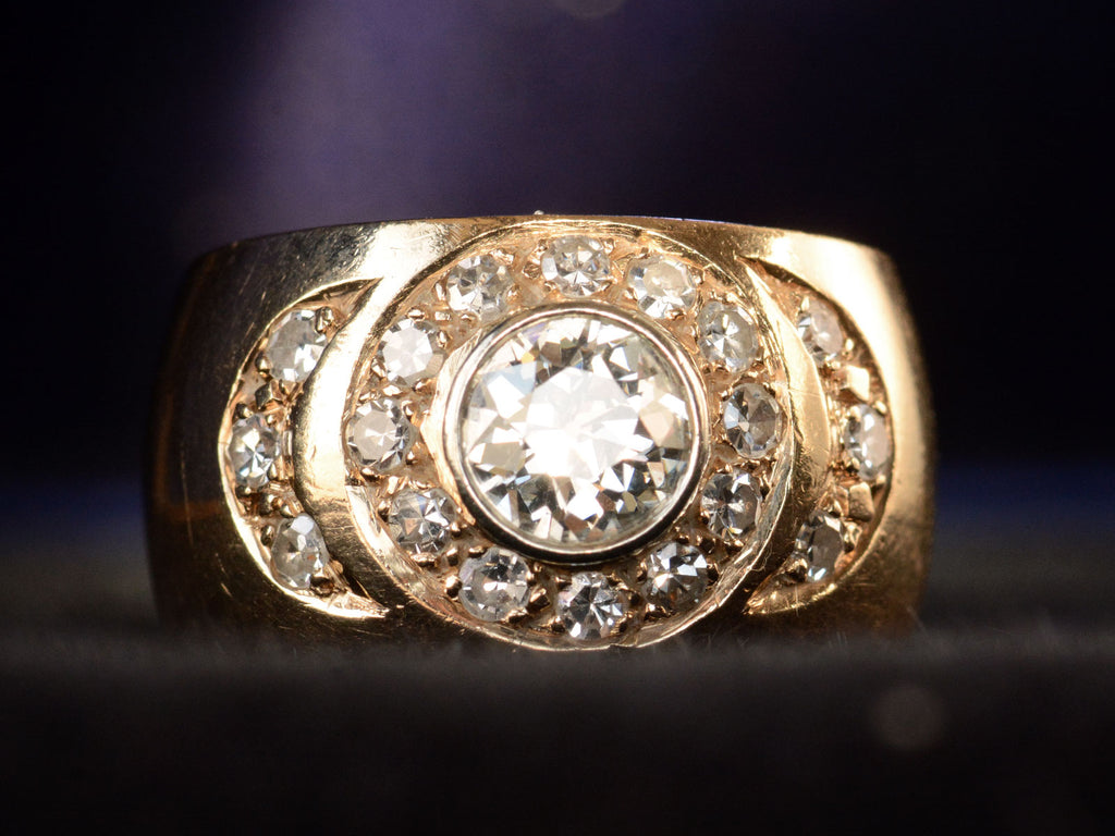 Front profile view of a c1980 Wide Yellow Gold Band set with Clusters of Old Cut Diamonds (on dark background)