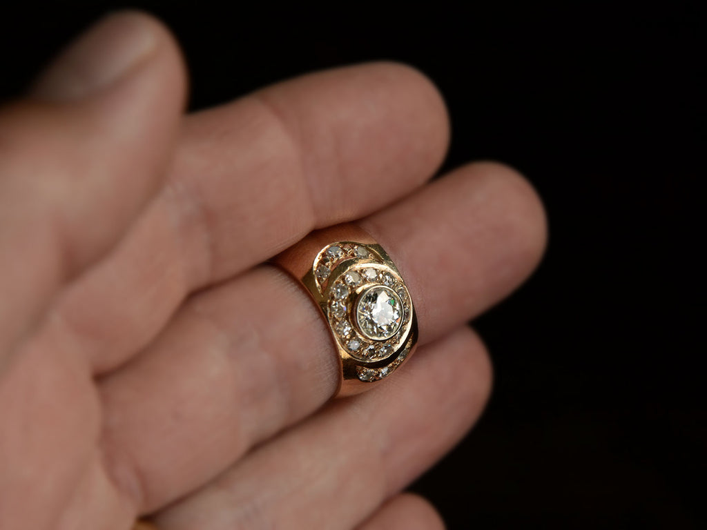 Angled front view of a c1980 Wide Yellow Gold Band set with Clusters of Old Cut Diamonds (on hand for scale)