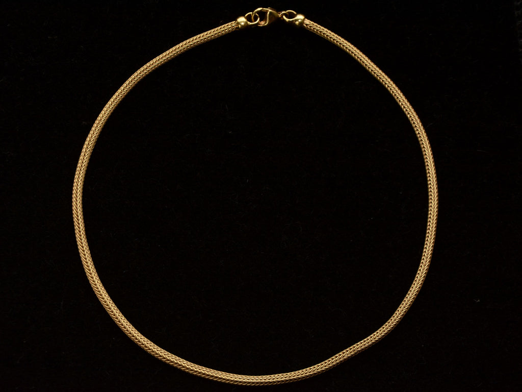 c1980 Woven 18K Yellow Gold Necklace Chain, shown laid out as it would hang on the neck on black background