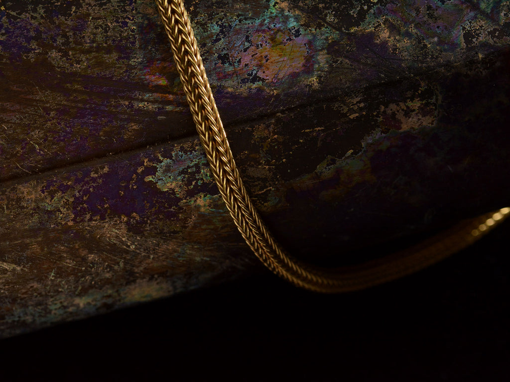 Detail of c1980 Woven 18K Yellow Gold Necklace Chain, shown on dark background