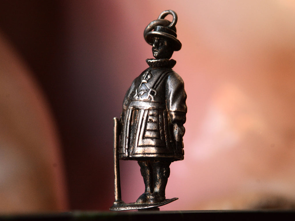 c1960 Silver Beefeater Charm (side angle view on pink background)