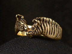 thumbnail of Angled view of two-headed zebra ring in 14K with black details, shown on dark background.