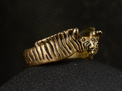 thumbnail of Left side view of two-headed zebra ring in 14K with black details, shown on dark background.